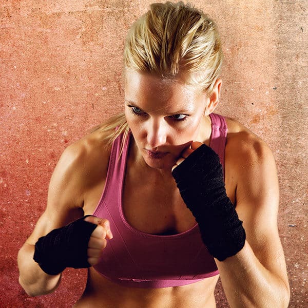 Mixed Martial Arts Lessons for Adults in Amarillo TX - Lady Kickboxing Focused Background