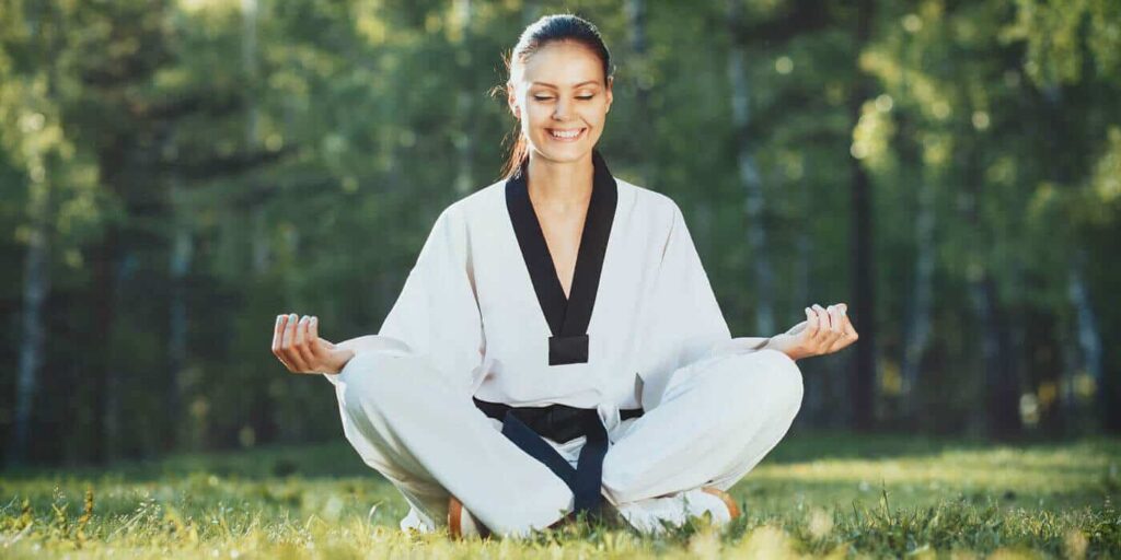 Martial Arts Lessons for Adults in Amarillo TX - Happy Woman Meditated Sitting Background